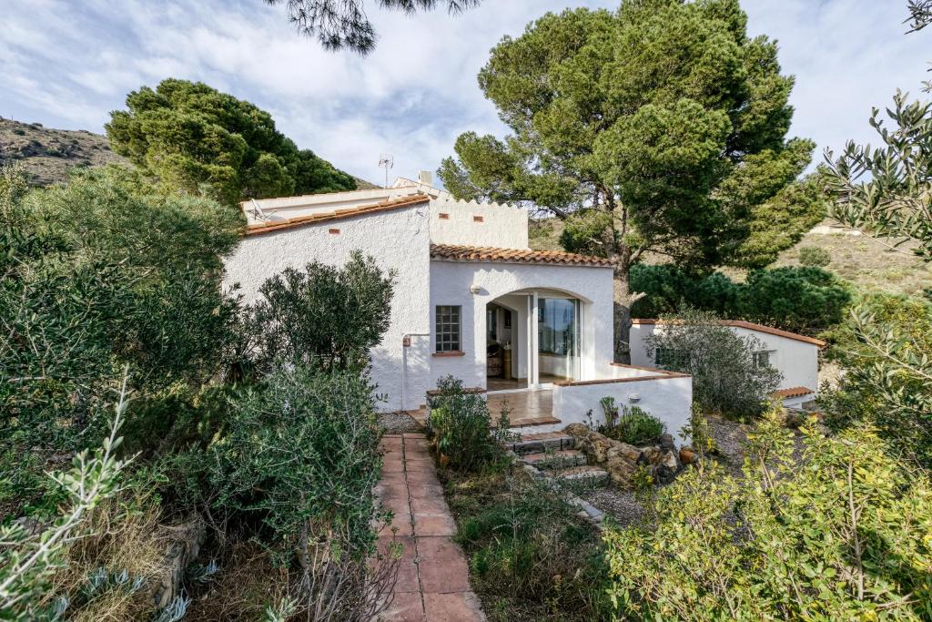 an image of a white house with trees at Casa Nostra - Tramuntana in Colera