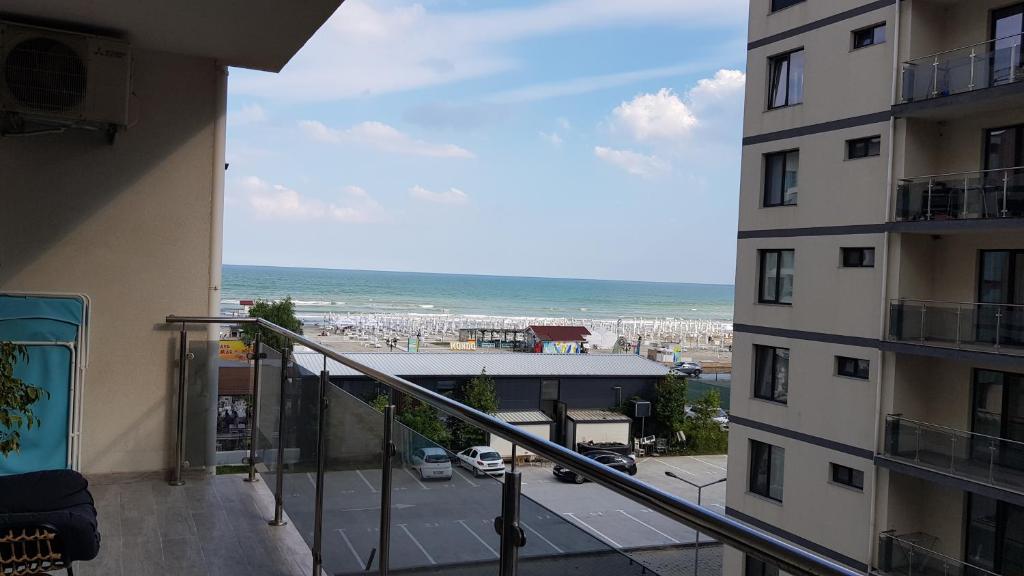 a balcony view of the beach from a building at Astoria Apartament vedere la mare in Mamaia Sat/Năvodari