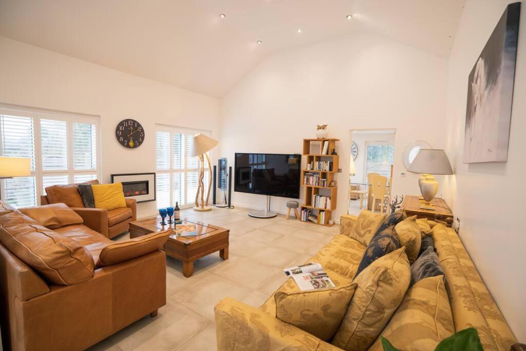 a living room with two couches and a tv at The Muse at Framlingham Sleeps 4 in Framlingham