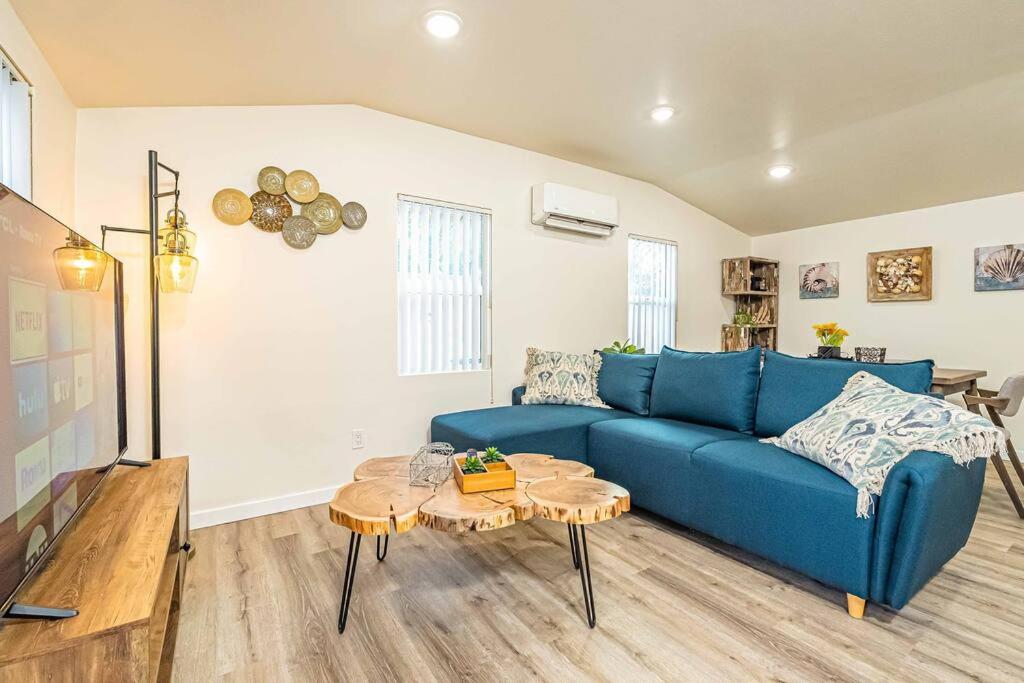 a living room with a blue couch and a table at NEW Charming Country Style 3B2B in Glendora