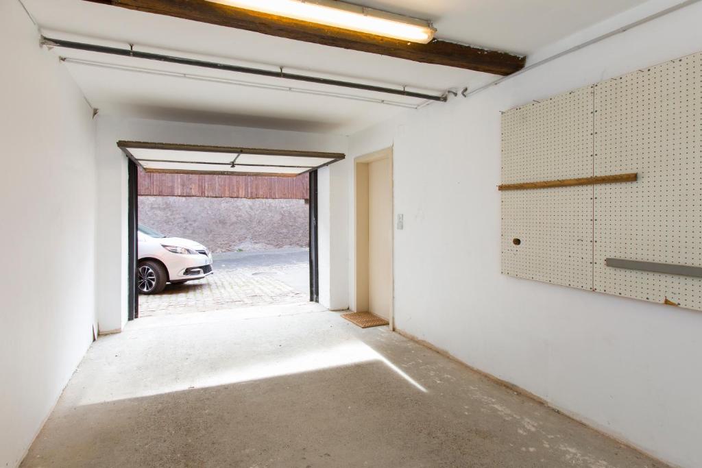 an empty room with a car parked in a garage at La couronne Maison 80m2 garage &amp; terrasse in Sainte-Croix-en-Plaine