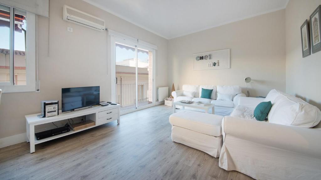 uma sala de estar branca com um sofá branco e uma televisão em TarracoHomes, TH37 Apartamento Sant Agusti em Tarragona