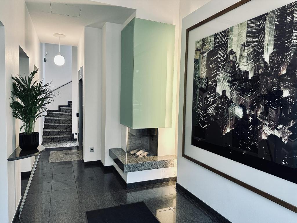 a hallway with a fireplace and a painting on the wall at AvidonApartments in Düsseldorf