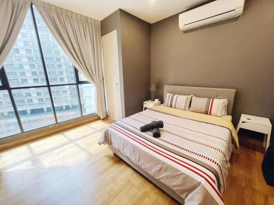 a bedroom with a large bed and a large window at [PROMO]Connected train 1 Bedroom (ABOVE MALL)6 in Kuala Lumpur