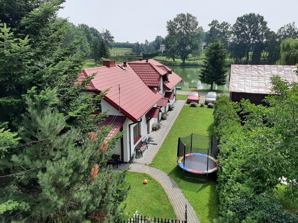 an aerial view of a house with a boat in the yard at Agroturystyka w Dolinie Stawów in Wąwolnica