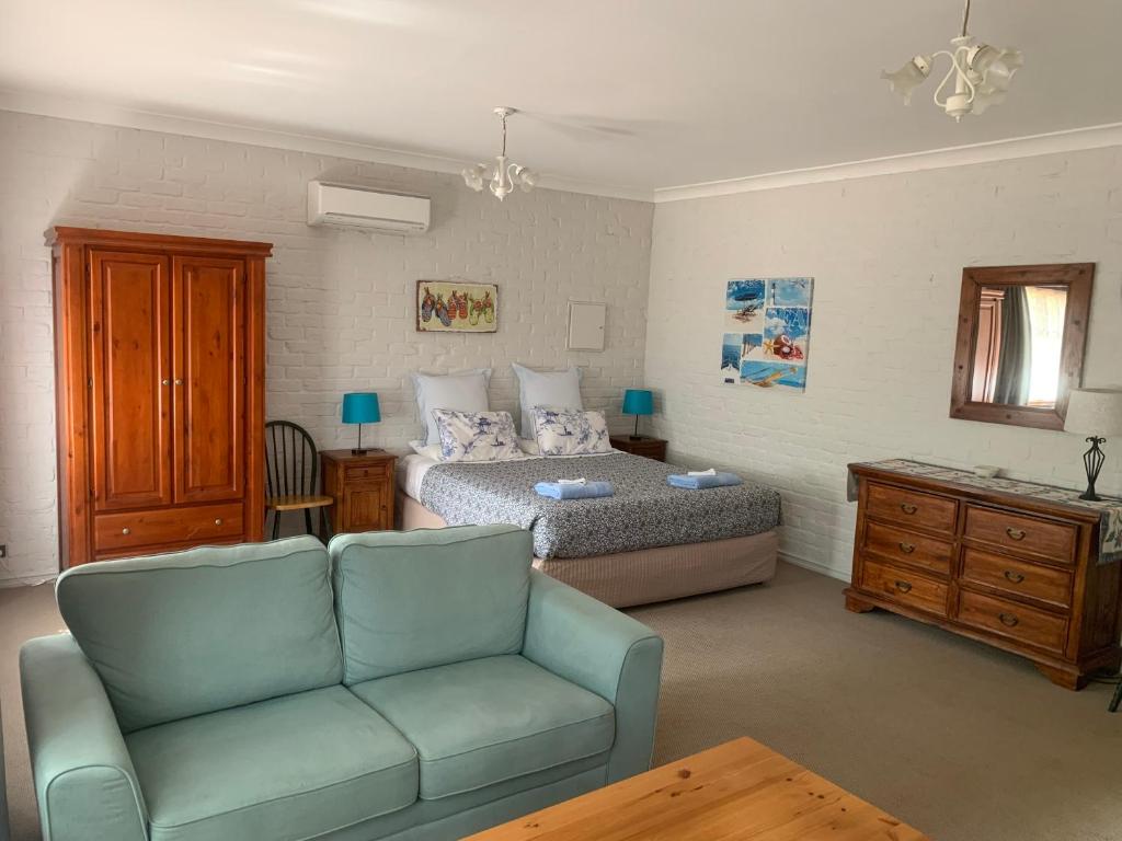 a living room with a couch and a bed at Bentworth Lodge in Carramar