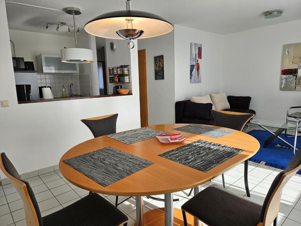 einen Esstisch und Stühle im Wohnzimmer in der Unterkunft Komfortables 3-Zimmer Apartment in Schwetzingen zwischen Mannheim und Heidelberg in Schwetzingen