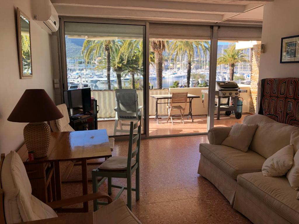 a living room with a couch and a table at Studio des îles in Cavalaire-sur-Mer