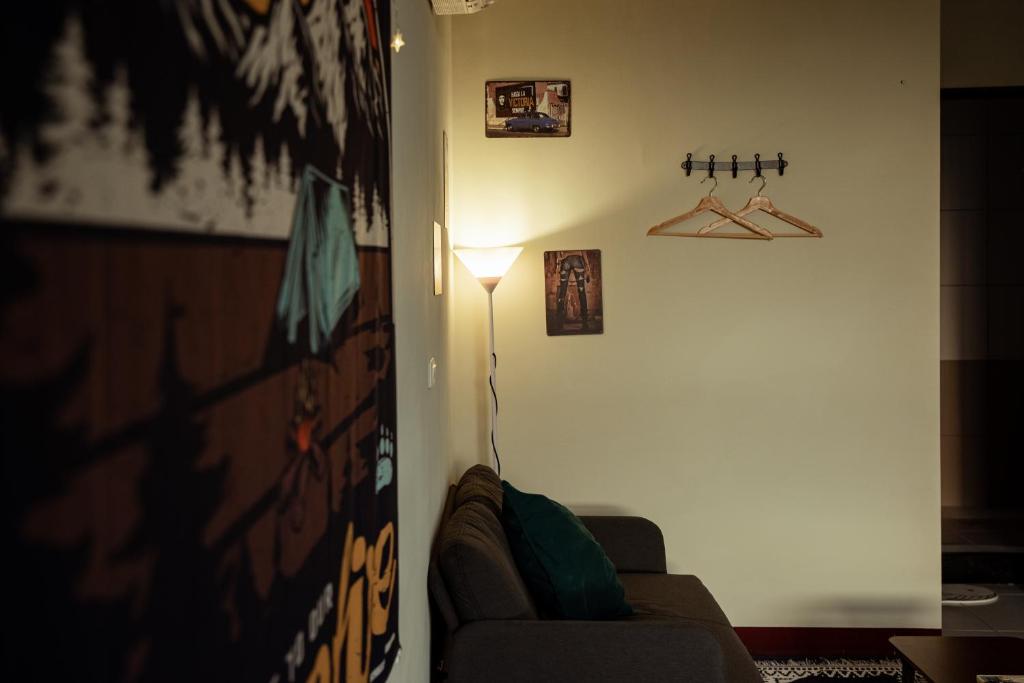 a living room with a couch and a lamp at Bare Foot Diving Hostel 2 in Hengchun
