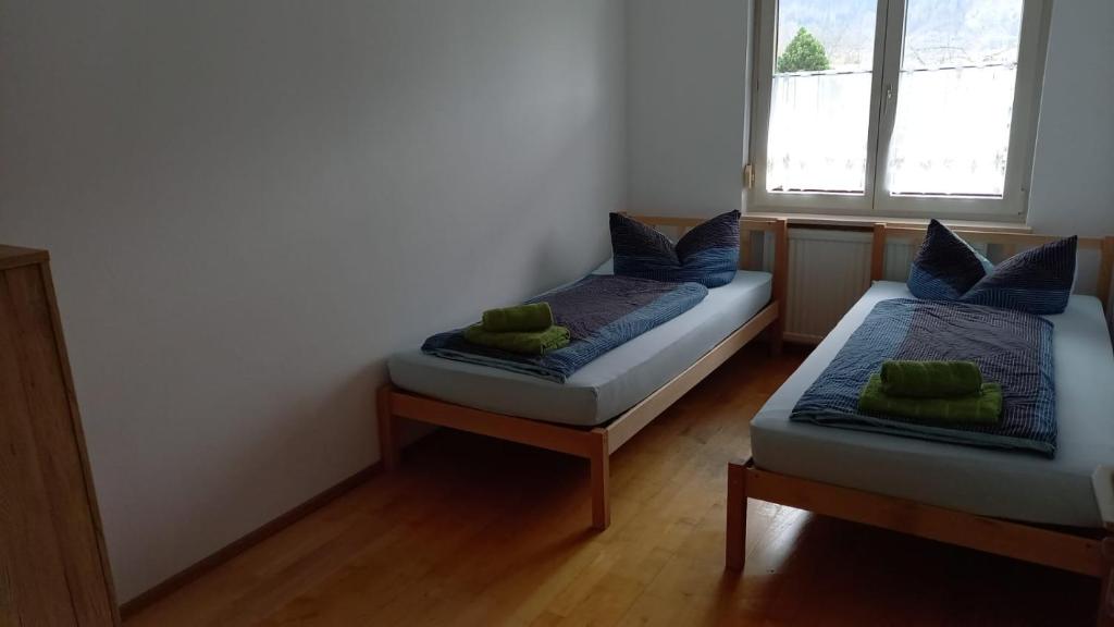 a bedroom with two beds and a window at Dimai House No 31 Dornbirn Messe in Dornbirn