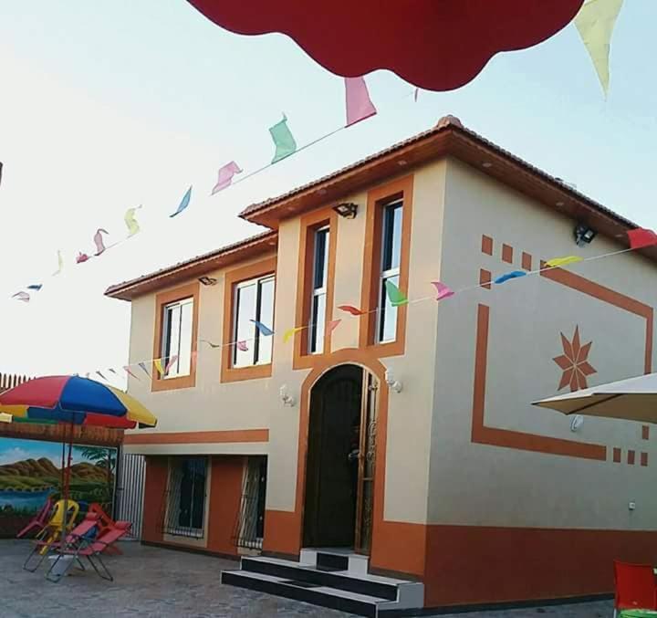 a house with a lot of flags in front of it at Furnished apartment for families only in Khān Yūnis