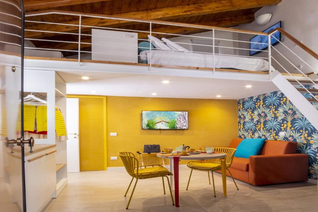 a room with a dining table and a loft bed at La Casetta a Sorrento in Sorrento