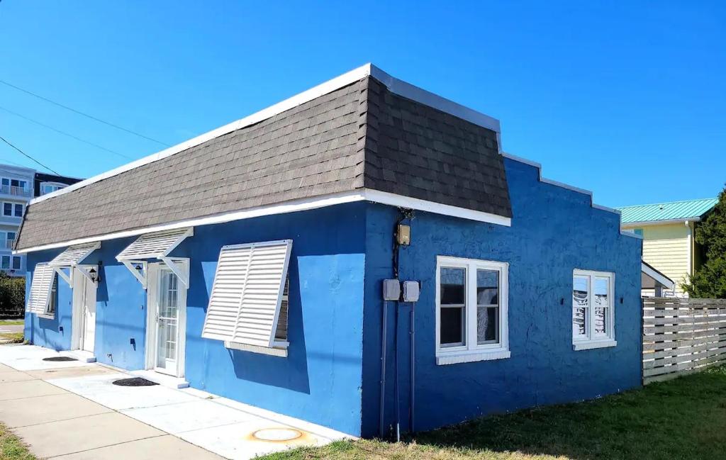 a blue tiny house with a black roof at Beachwood Bungalow B in Carolina Beach
