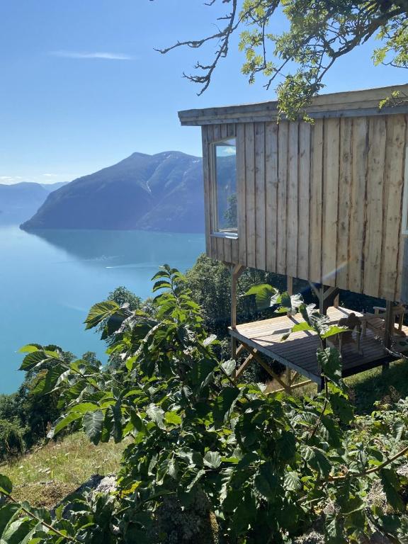 a tree house with a view of the ocean at Raaum Gard, hytte 2 in Hafslo