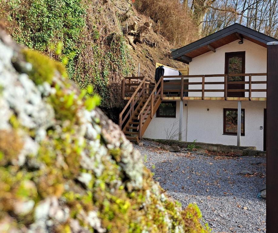 a small house with a wooden staircase in front of it at La cabane d'Achille - La Roche-en-Ardenne in La Roche-en-Ardenne