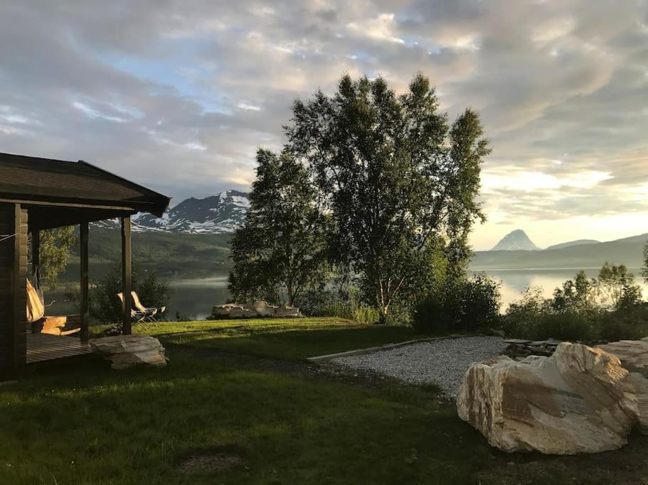 a house with a view of a lake and mountains at Villa Hegge - Design Cabin with fab view in Sjøvegan