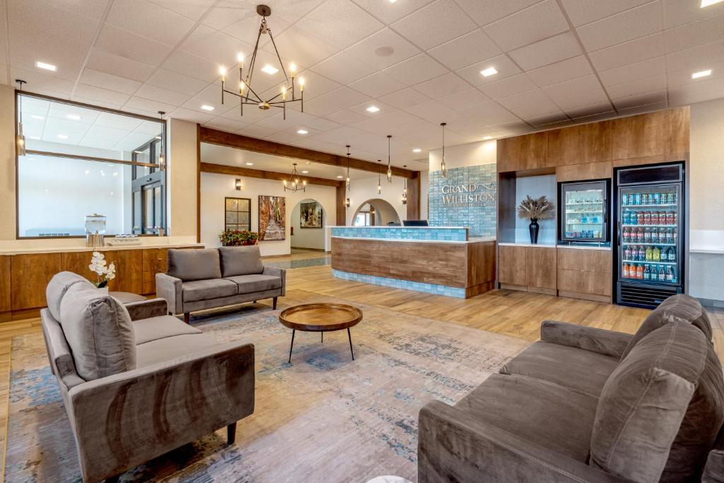 a lobby with couches and a waiting room at Grand Williston Hotel and Conference Center in Williston