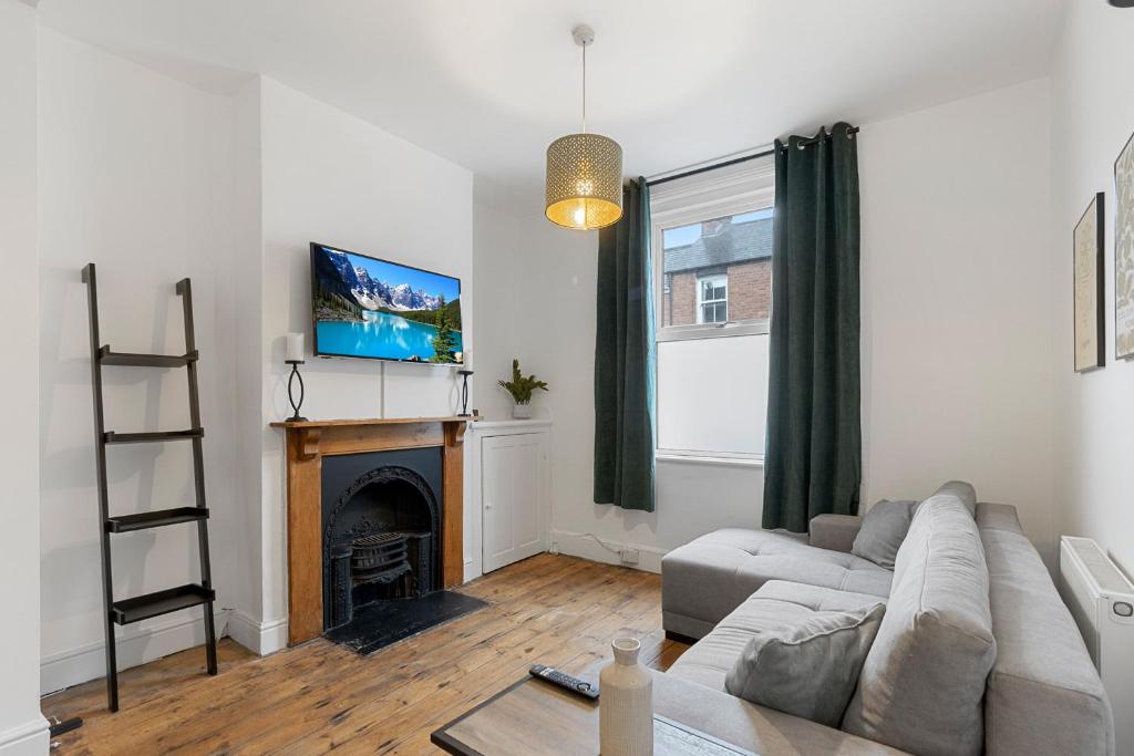 a living room with a couch and a fireplace at Church View II by Staytor Accommodation in Exeter