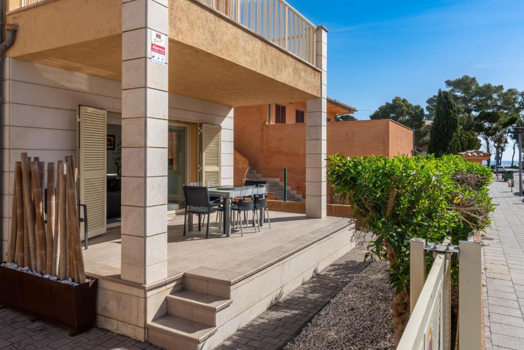 a house with a deck with a table and chairs at M4R Casa Iuca in Alcudia