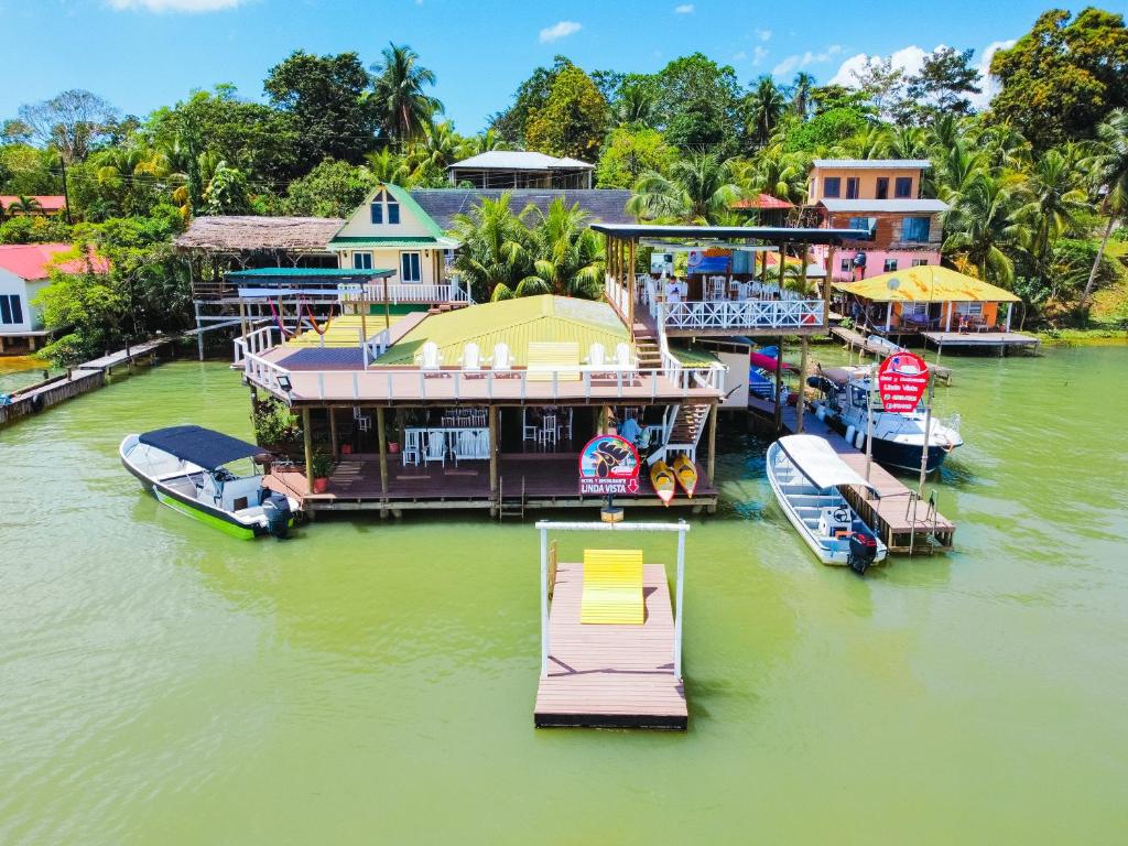 a large house on a river with boats docked at Linda Vista in Río Dulce