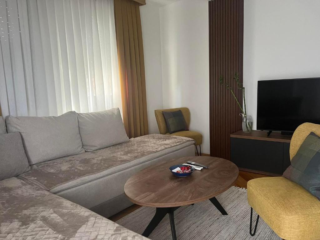 a living room with a couch and a coffee table at Kuman Apartments in Kumanovo