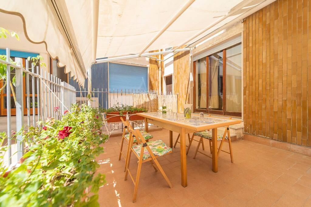 a patio with a table and chairs in a building at "Conchiglia" big house in the center of Maiori in Maiori