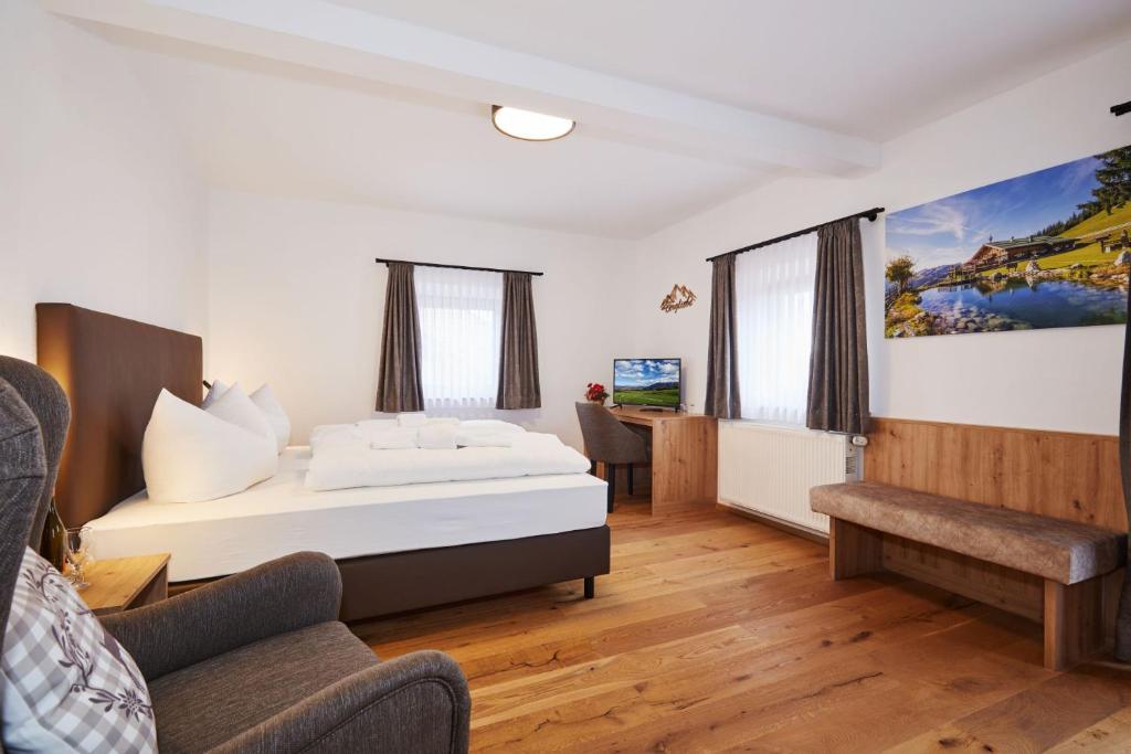 um quarto de hotel com uma cama e uma secretária em Das Salzburgblick em Ainring