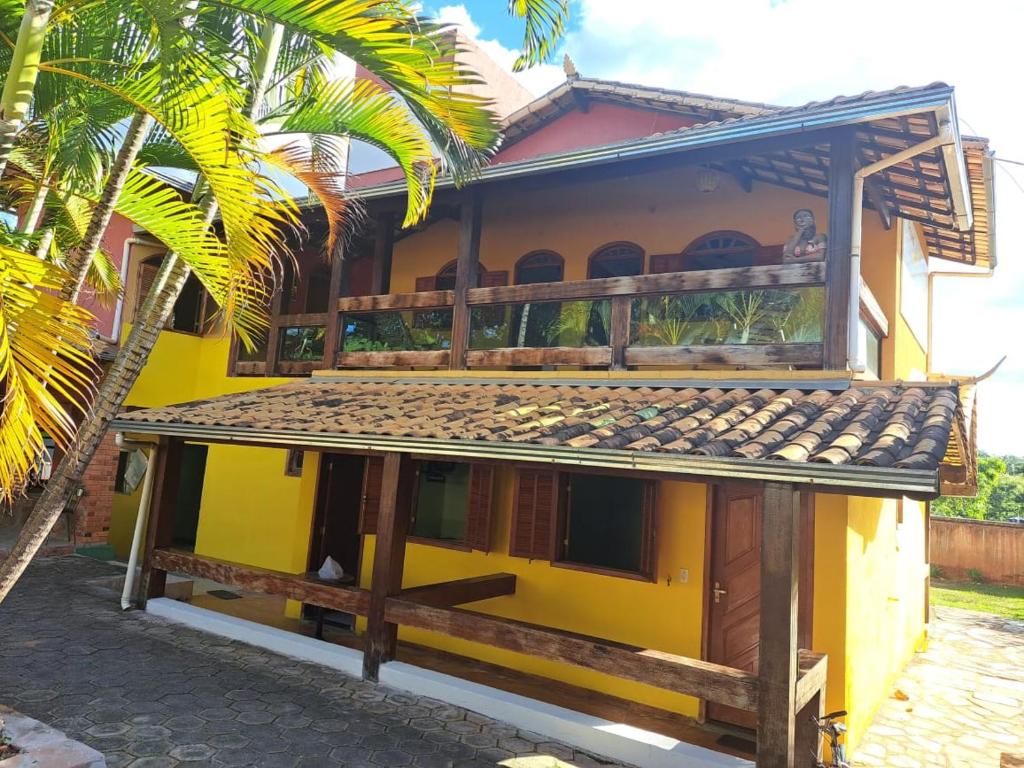 a yellow house with a balcony on top of it at Pousada por do soll in Serra do Cipo