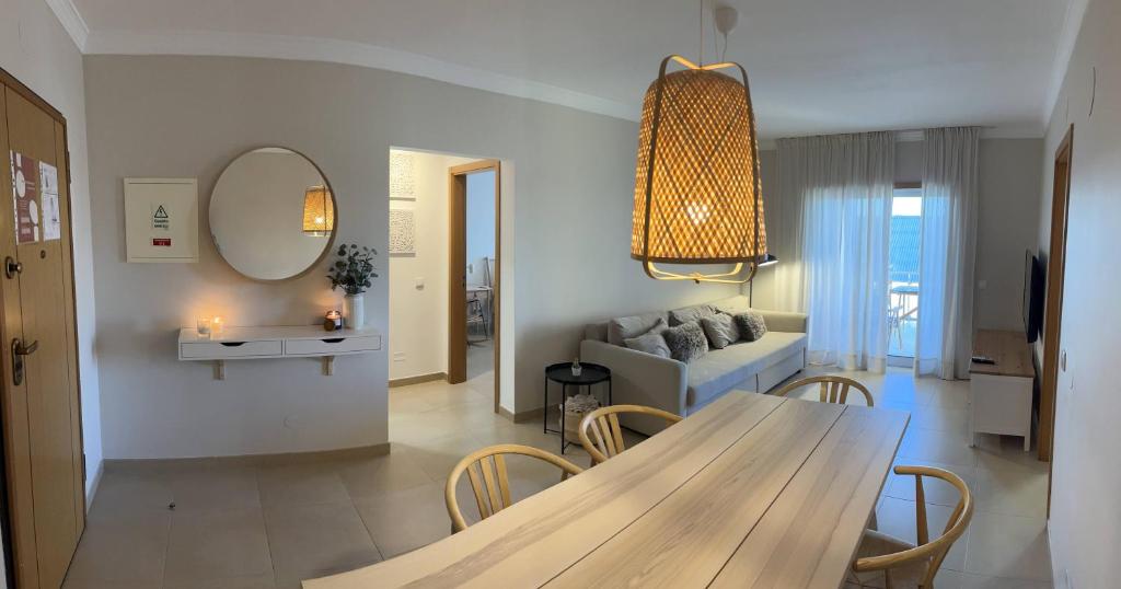 a living room with a table and a couch at Rias Apart II in Vila Real de Santo António