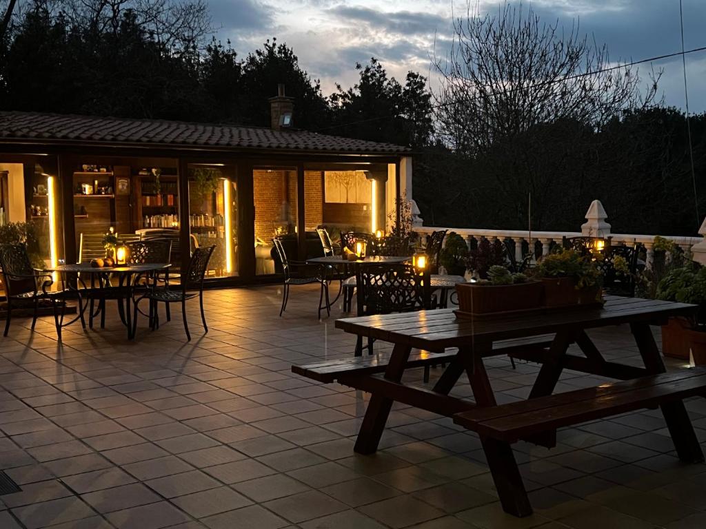 a patio with tables and chairs and a building at Posada La Vieja Escuela in La Revilla
