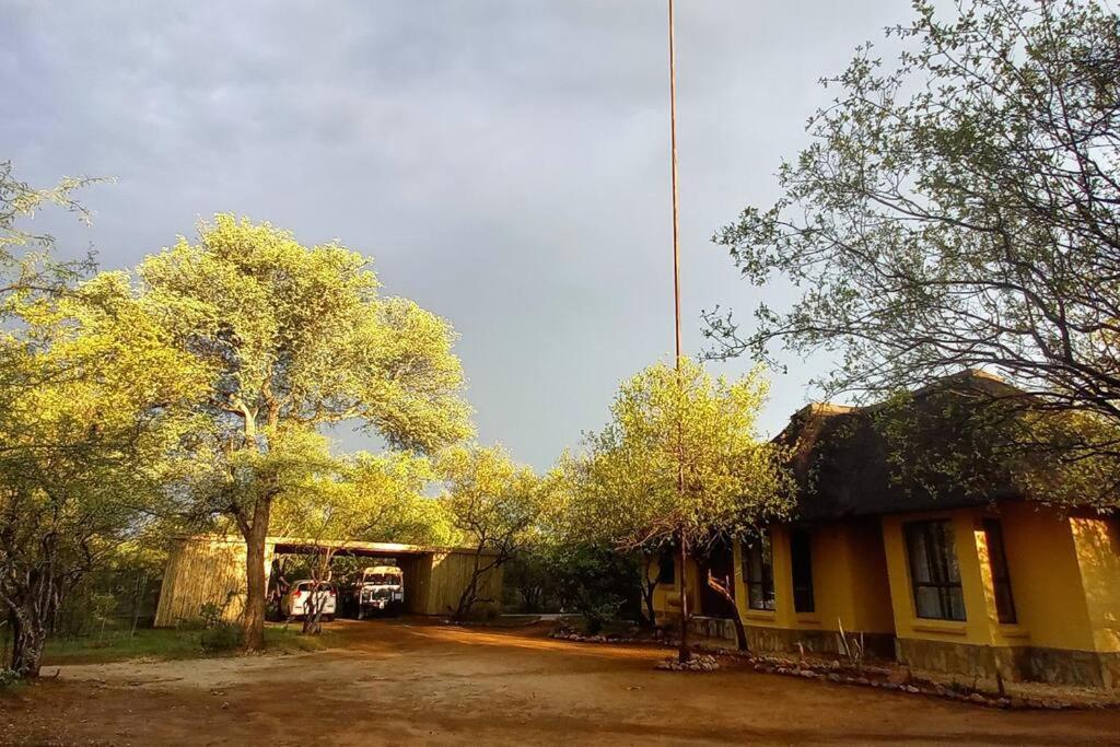a house with a crane on top of it at Hoedspruit Bush Cottage in Hoedspruit