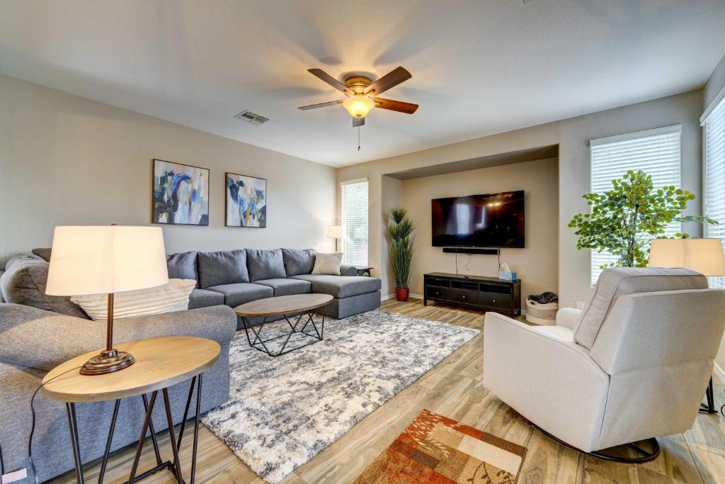 a living room with a couch and a tv at Updated Gilbert Home with Pool and Community Amenities in Queen Creek
