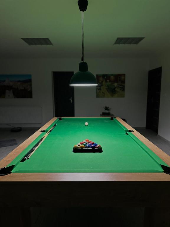 a green pool table with a ball on it at Apartmán Pantáreň in Stará Bystrica