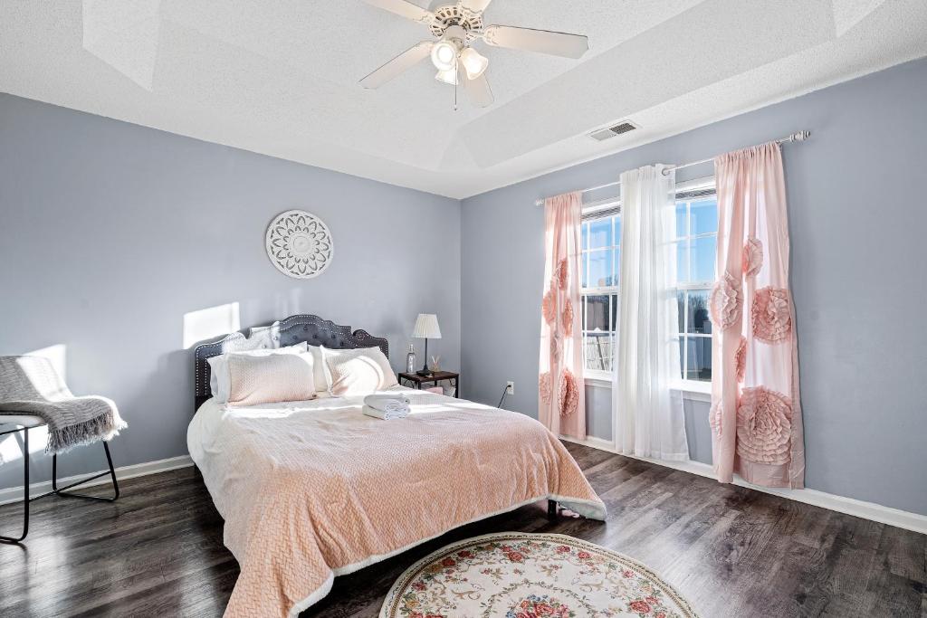 a bedroom with a bed and a ceiling fan at Locked In in Charlotte