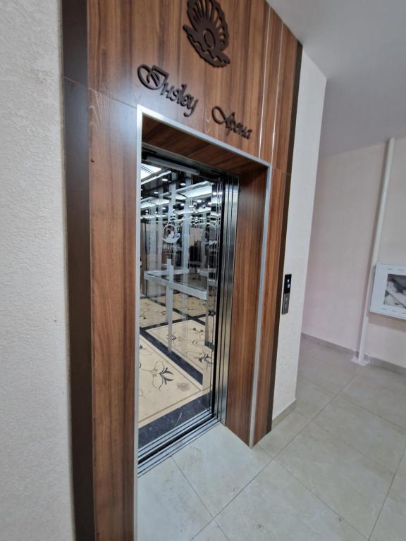 a wooden elevator in a building with a window at INJU апартаменты in Taldykolʼ