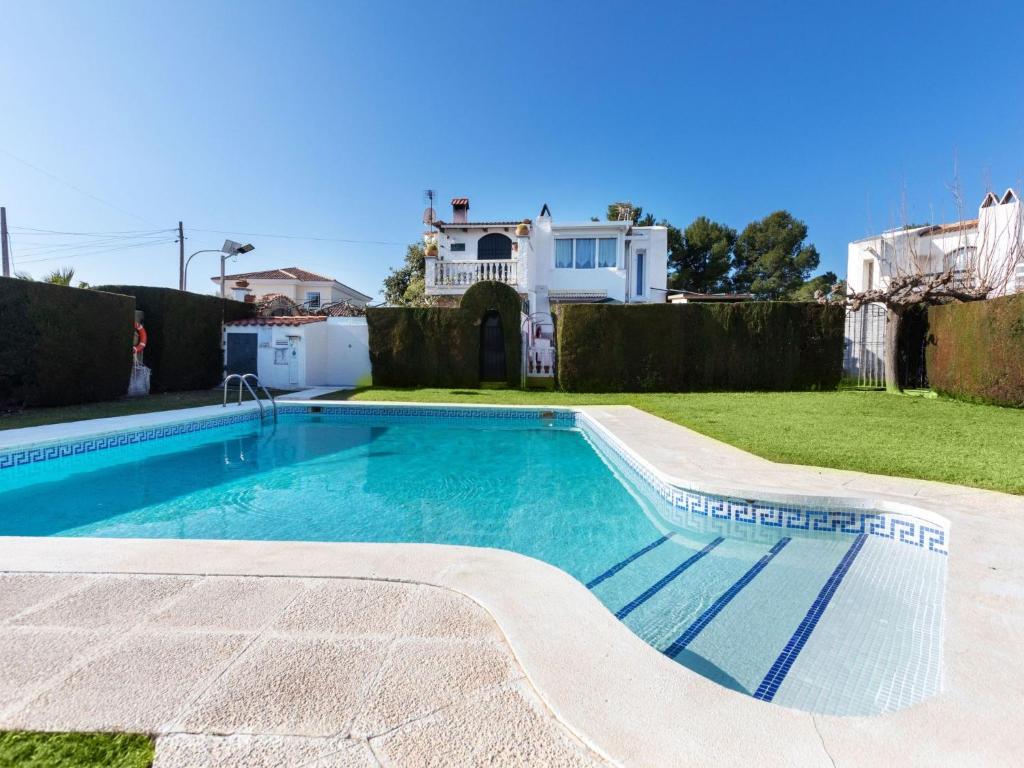 a swimming pool in the yard of a house at Holiday Home Eden Park 2 by Interhome in Miami Platja