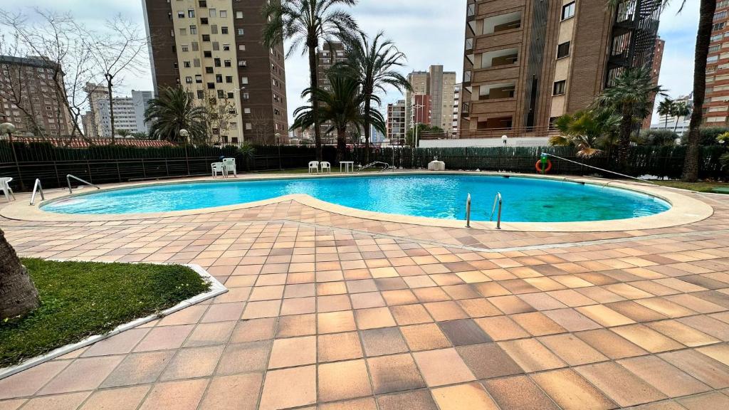 a swimming pool in a city with tall buildings at Esperanto 17. in Benidorm