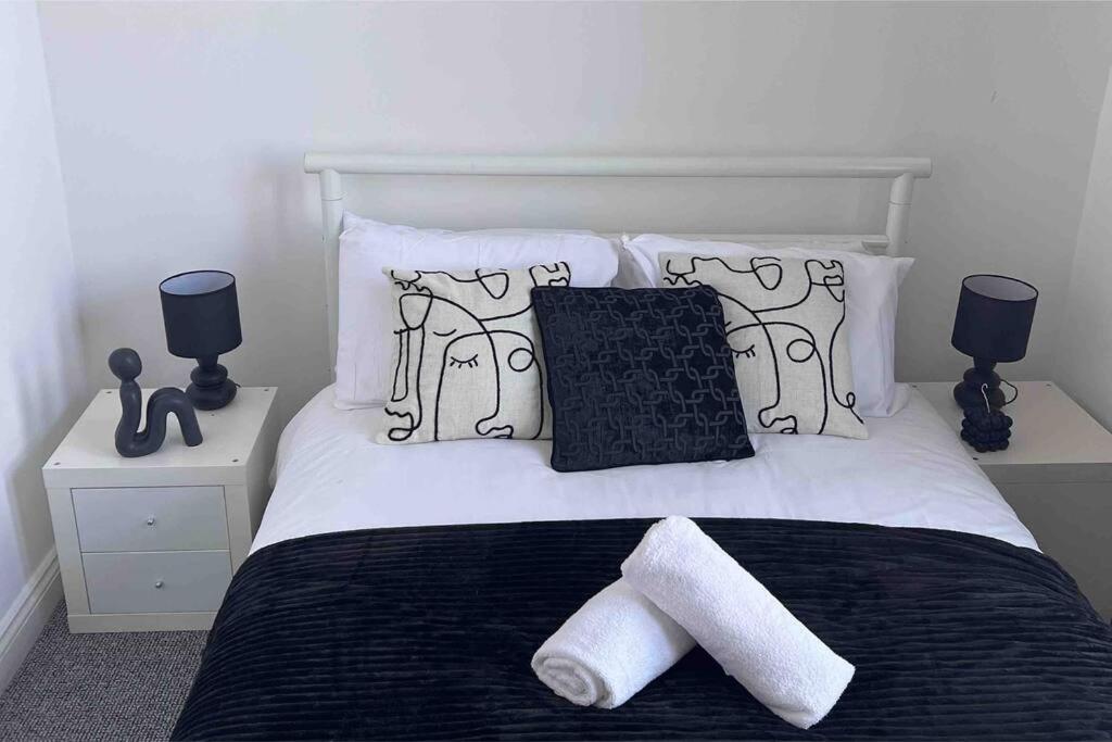 a bedroom with a bed with two towels on it at Cosy apartment near Newcastle in Gateshead