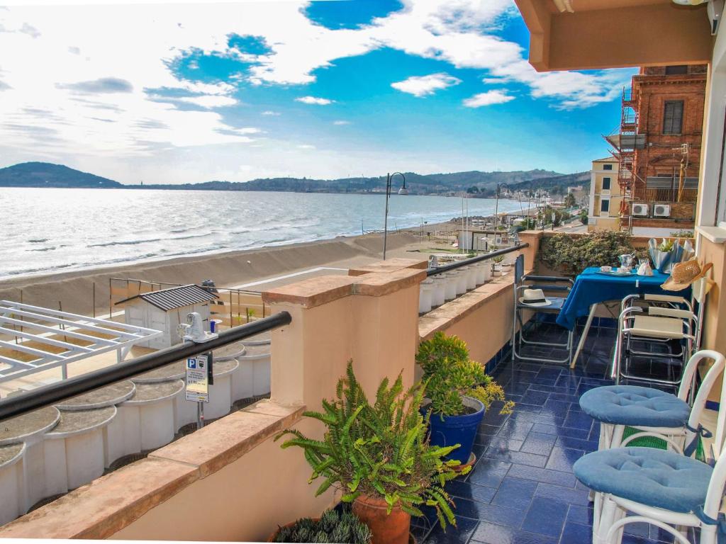 a balcony with chairs and a view of the water at Apartment Sul mare by Interhome in Vendicio