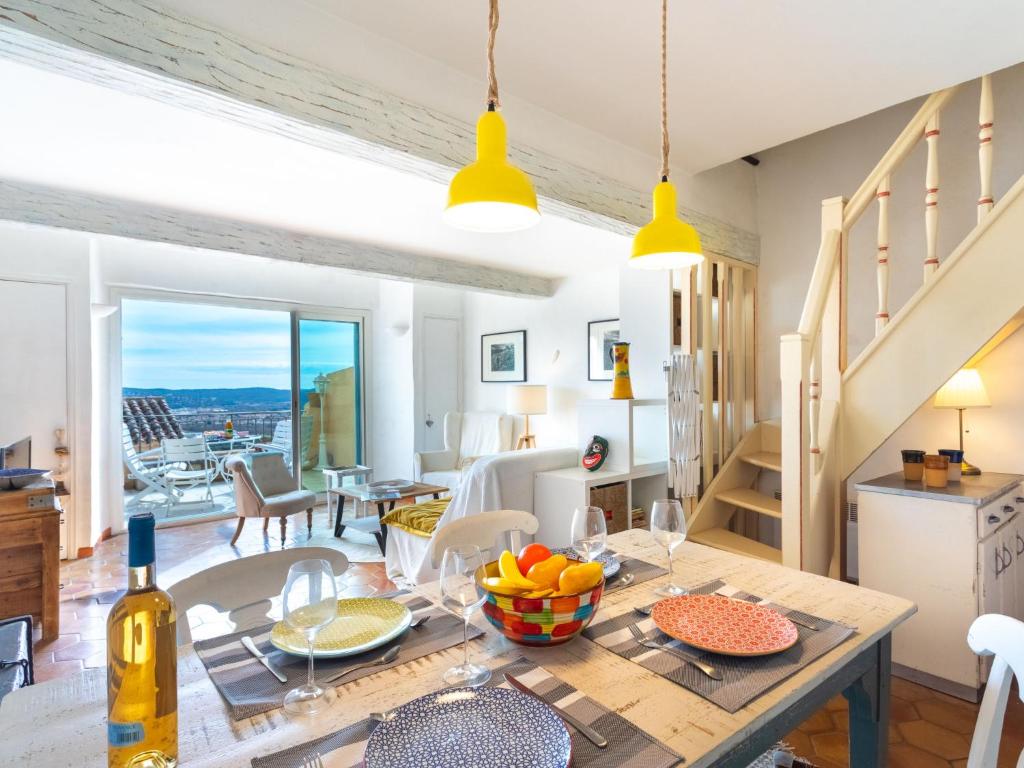 a kitchen and living room with a table with fruit on it at Apartment Village de Silhouette-8 by Interhome in Grimaud