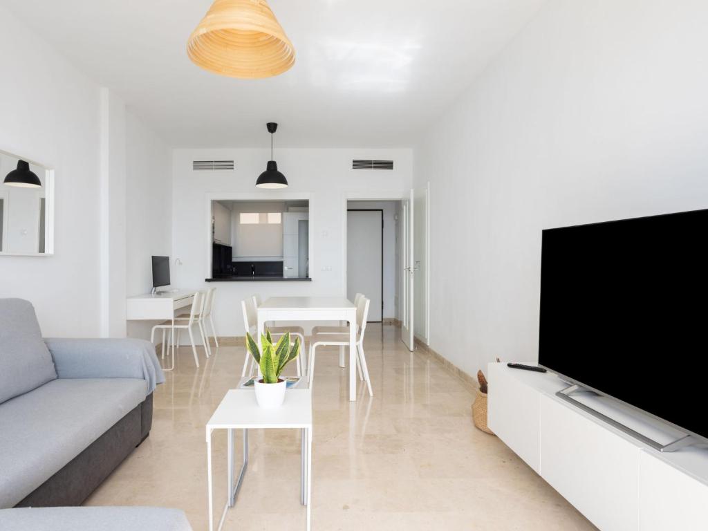 A television and/or entertainment centre at Apartment Playa Negra II by Interhome
