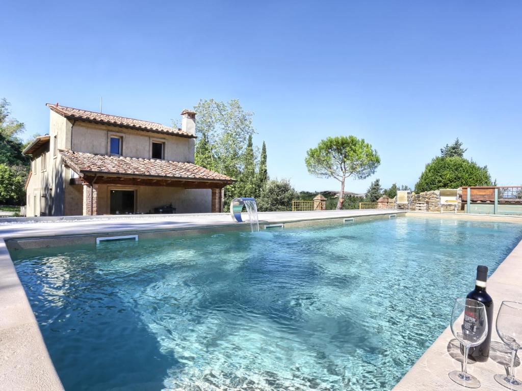 a swimming pool in front of a house at Villa Oliva by Interhome in Querce