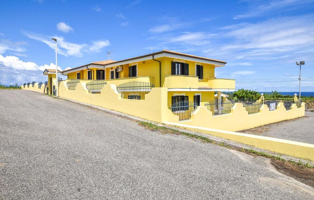 a yellow house on the side of a road at Villa Maria Carmela in Briatico