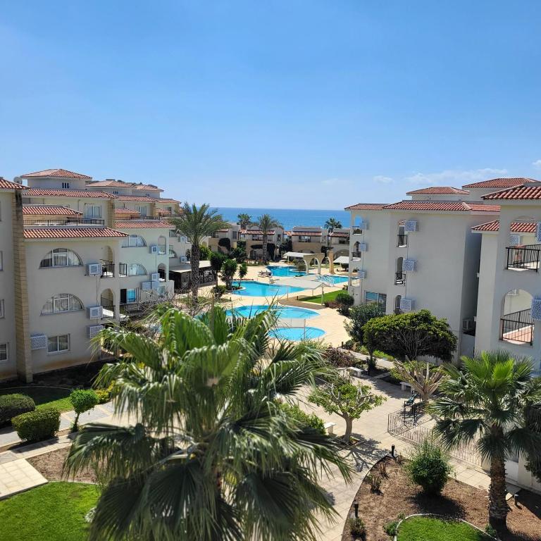 an aerial view of a resort with a pool and palm trees at SUMMER TERRACE 26 in Kalecik