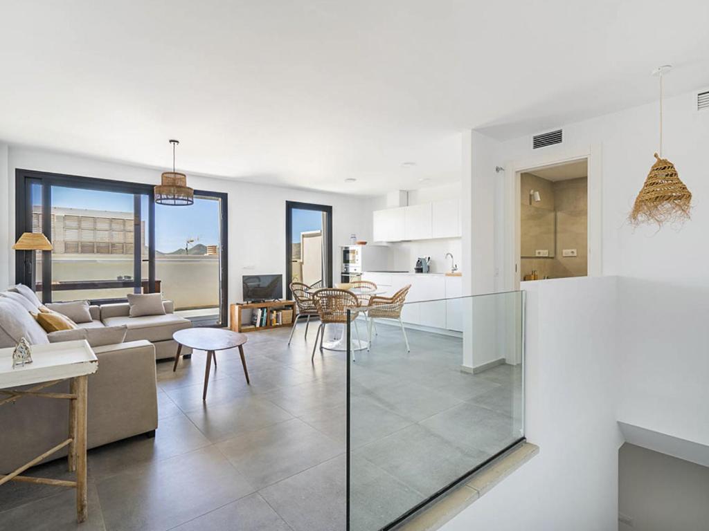 a kitchen and living room with a couch and a table at Casa Ailanto in El Pozo de los Frailes