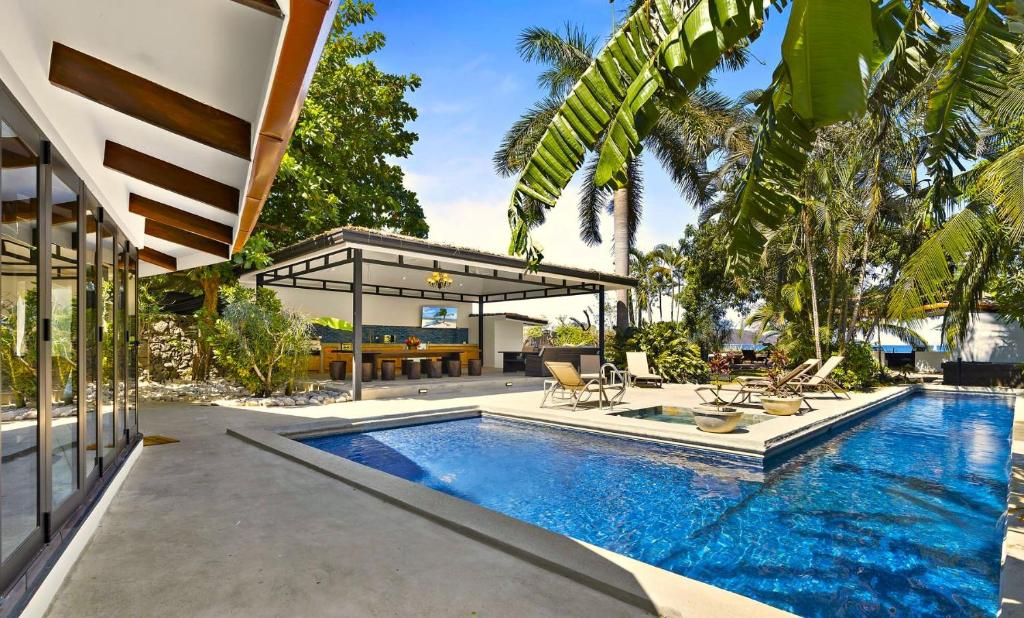 a swimming pool in the backyard of a house at Playa Potrero - beachfront Villa, big private pool - Casa Bella Catalina in Potrero