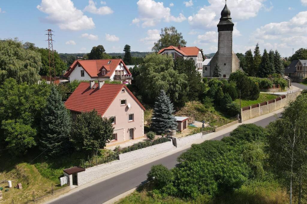 a small village with a church and a road at Pod Wieżą u Kory in Siedlęcin