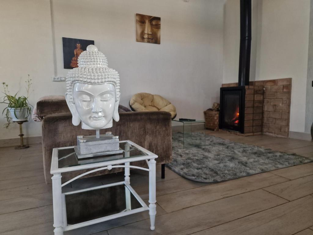 a living room with a statue of a head on a table at A Casa da Lúa in Nieves