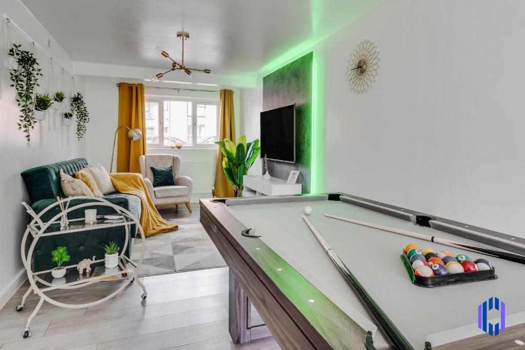 a living room with a pool table at Spacious 5 BR Home Nr Etihad Stadium with Pool Table in Manchester