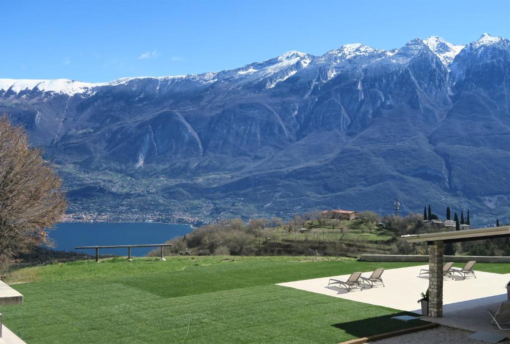 a patio with two chairs and a view of a mountain at OASI DA VINCI in Tignale